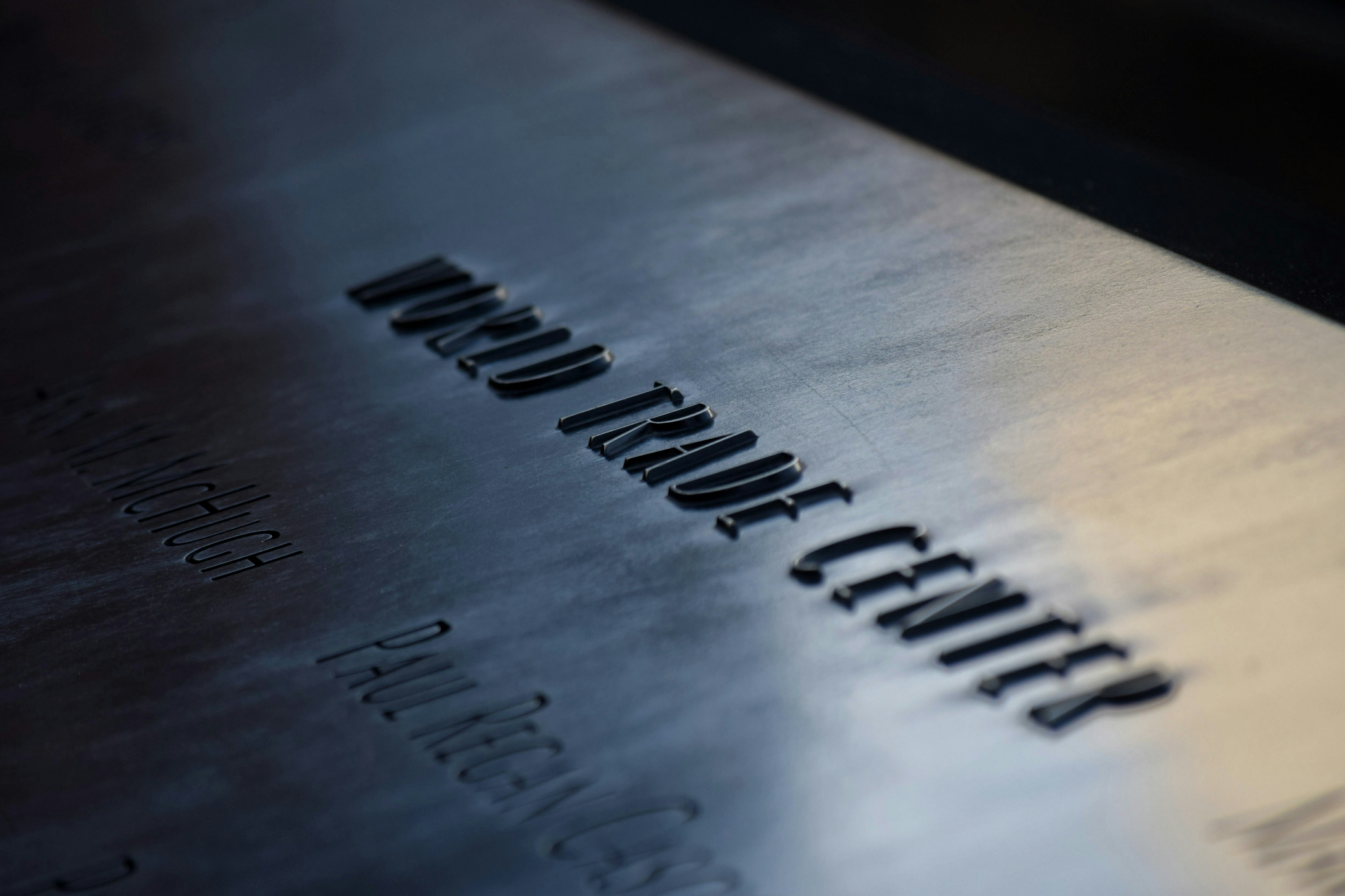 Close-up of victims' names engraved into the bronze parapet of the 9/11 Memorial
